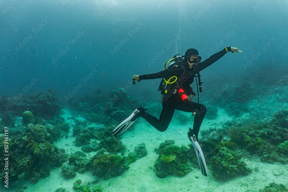 Female scuba diver striking a pose in Komodo Female scuba diver striking a pose in Komodo