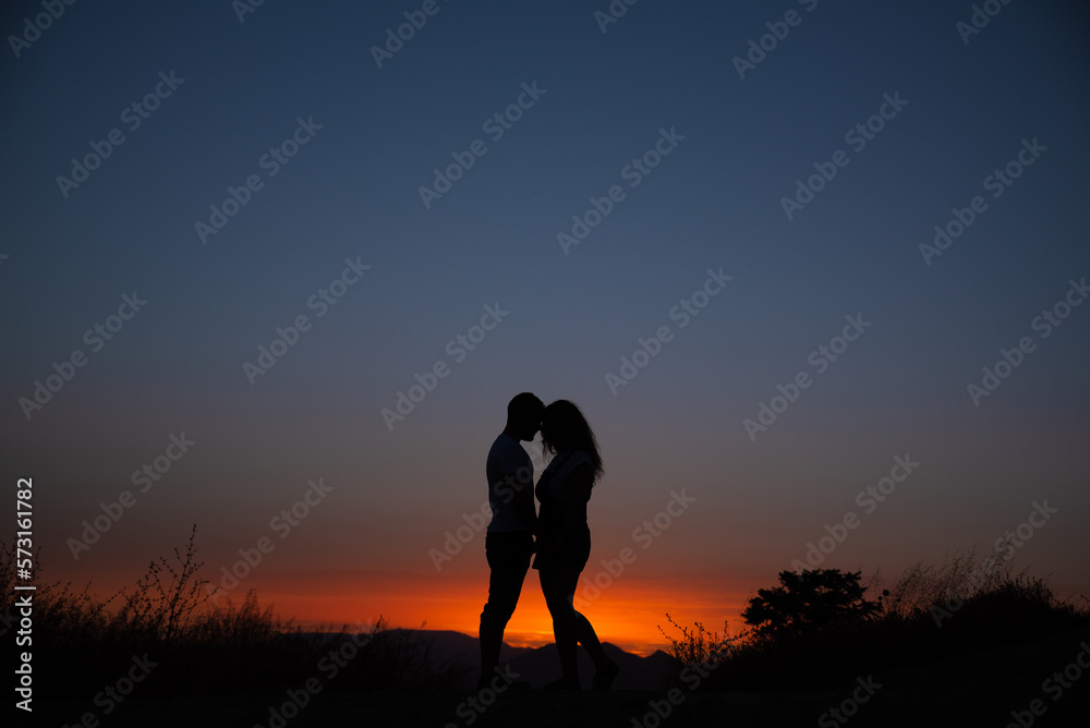 Young couple enjoying the sunset. Young couple enjoying the sunset.