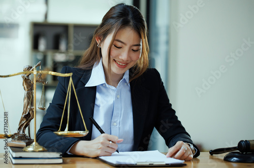 Young asian lawyer woman working at table office, law and justice concept, law contract.	