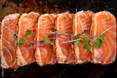Fillet of fresh smoked salmon sliced on a plate with soy sauce. Asian dish sashimi from raw salmon, close up