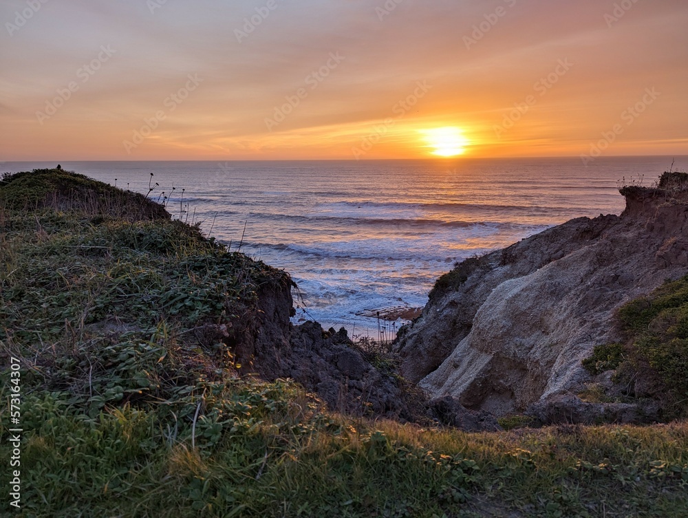 sunset over the Pacific Ocean, sunset in Half Moon Bay State Beach cliff side landscape