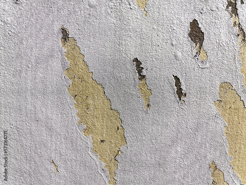Texture background of White Paint Peel off on Yellow Wall