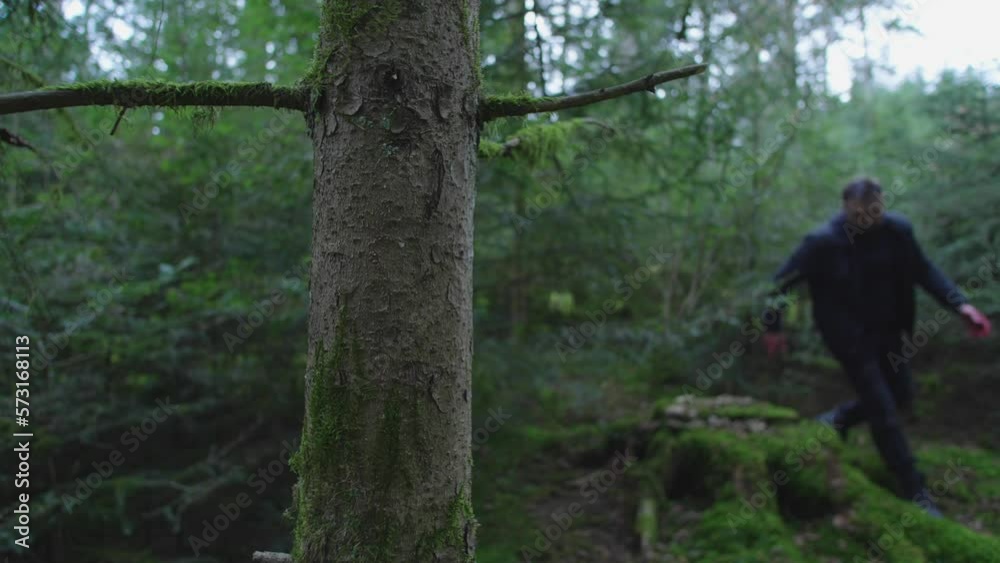 tired and wounded man running through the woods tired and wounded man running through the woods