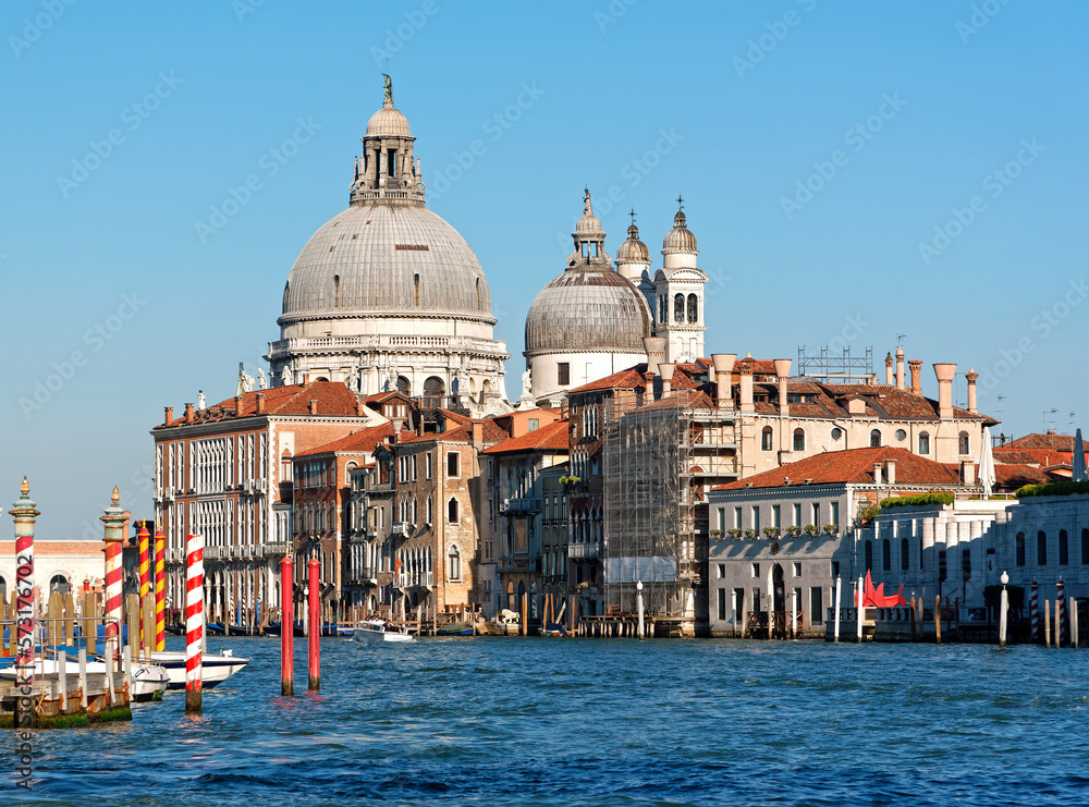 Grand canal in Venice with old houses and the church Santa Maria della Salute in the background