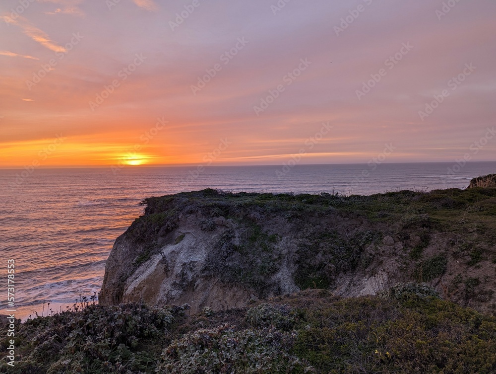 sunset over the Pacific Ocean, sunset in Half Moon Bay State Beach cliff side landscape
