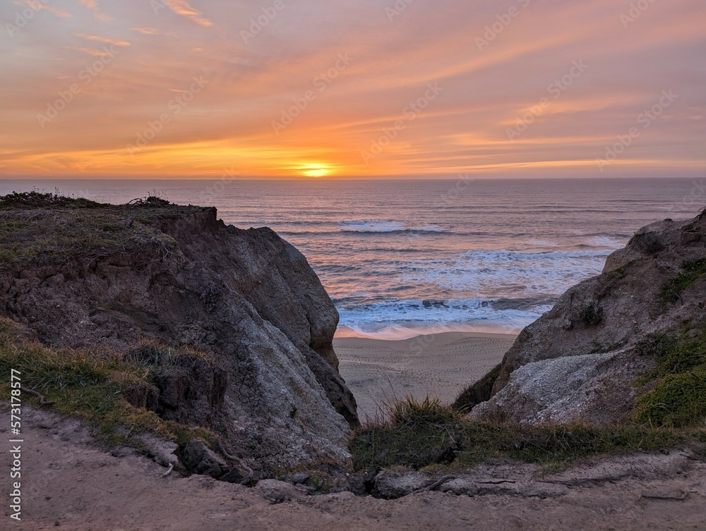 sunset over the Pacific Ocean, sunset in Half Moon Bay State Beach cliff side landscape
