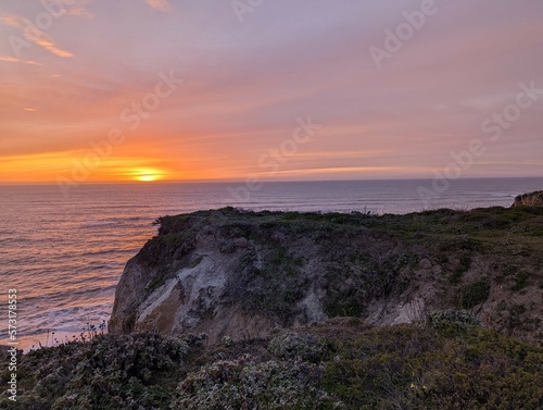sunset over the Pacific Ocean, sunset in Half Moon Bay State Beach cliff side landscape 