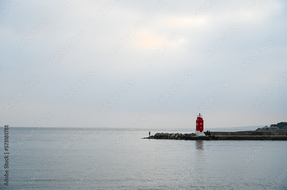 Cloudy day at sea. A lighthouse on the coast. Adriatic sea. 