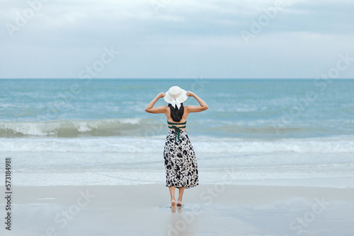 Traveler asian woman relax and travel on beach in Thailand photo