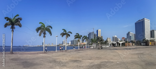 Panoramic view at the Luanda bay and Luanda marginal, pedestrian pathway with tropical palm trees, downtown lifestyle, Cabo Island, Port of Luanda and modern skyscrapers