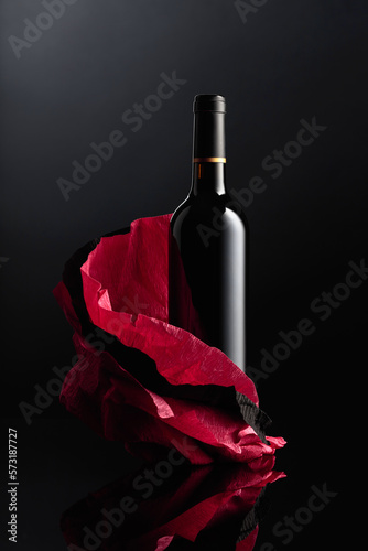 Bottle of red wine on a crumpled paper.