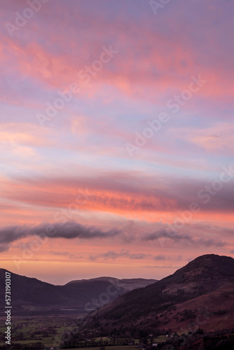 Beautiful colorful Winter sunset landscape over Skiddaw range looking towards Bassenthwaite Lake in Lake District