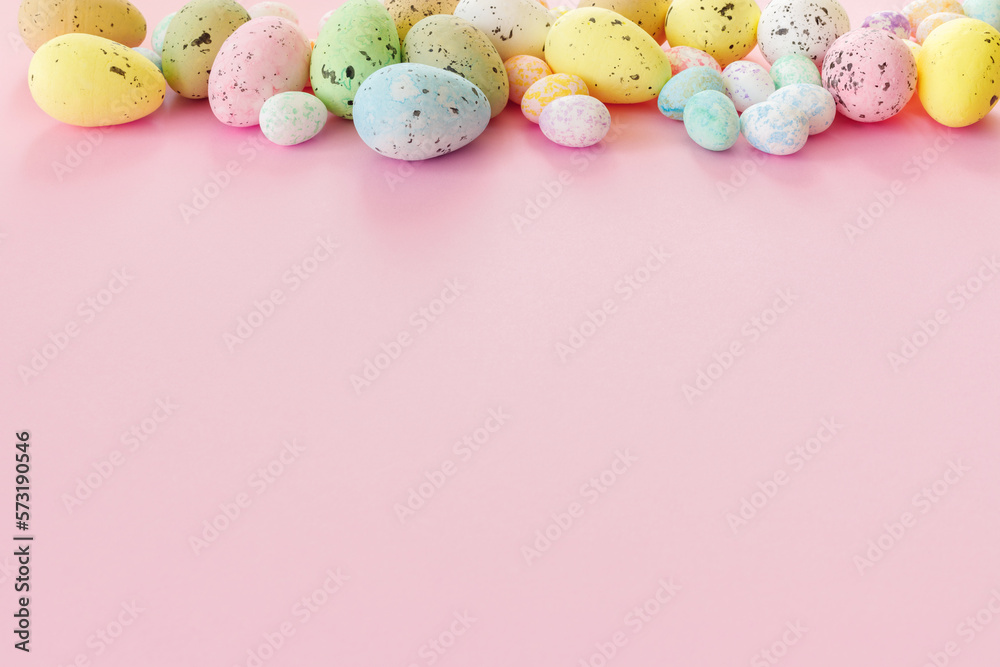 Beautiful Easter card with colorful eggs on paper pink background.