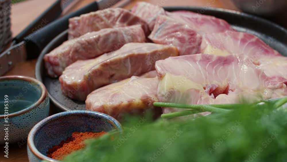 Raw fish steaks on a plate. Sturgeon meat.