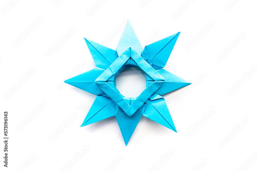 blue paper star on a white background. origami. papercraft. needlework blue paper star on a white background. origami. papercraft. needlework