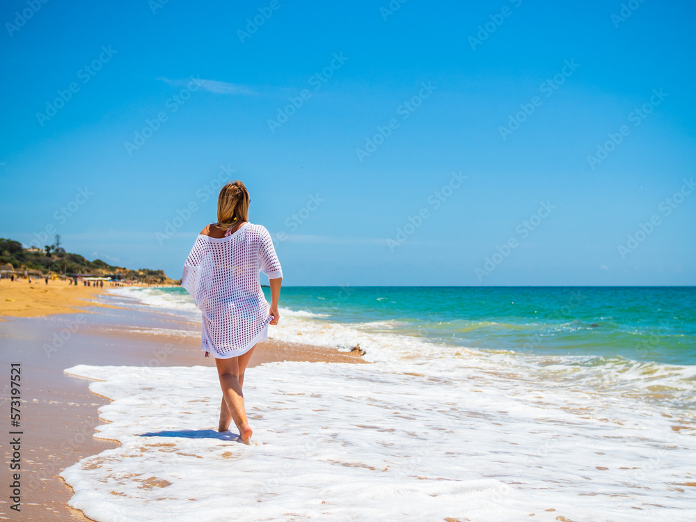 Beautiful woman walking on sunny beach
Beautiful woman walking on sunny beach