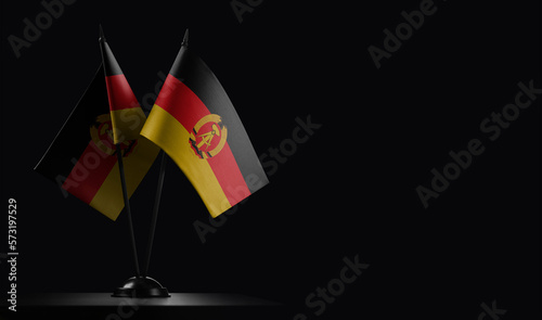 Small national flags of the DDR on a black background