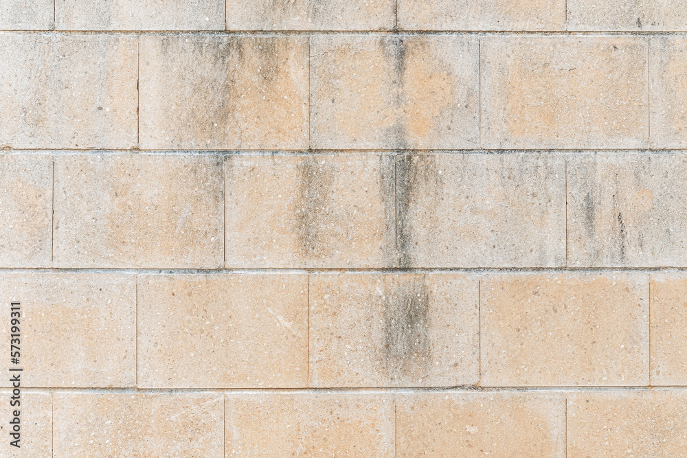 Naklejka premium abstract background of an old beige brick wall texture close up