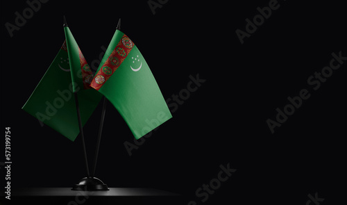 Small national flags of the Turkmenistan on a black background