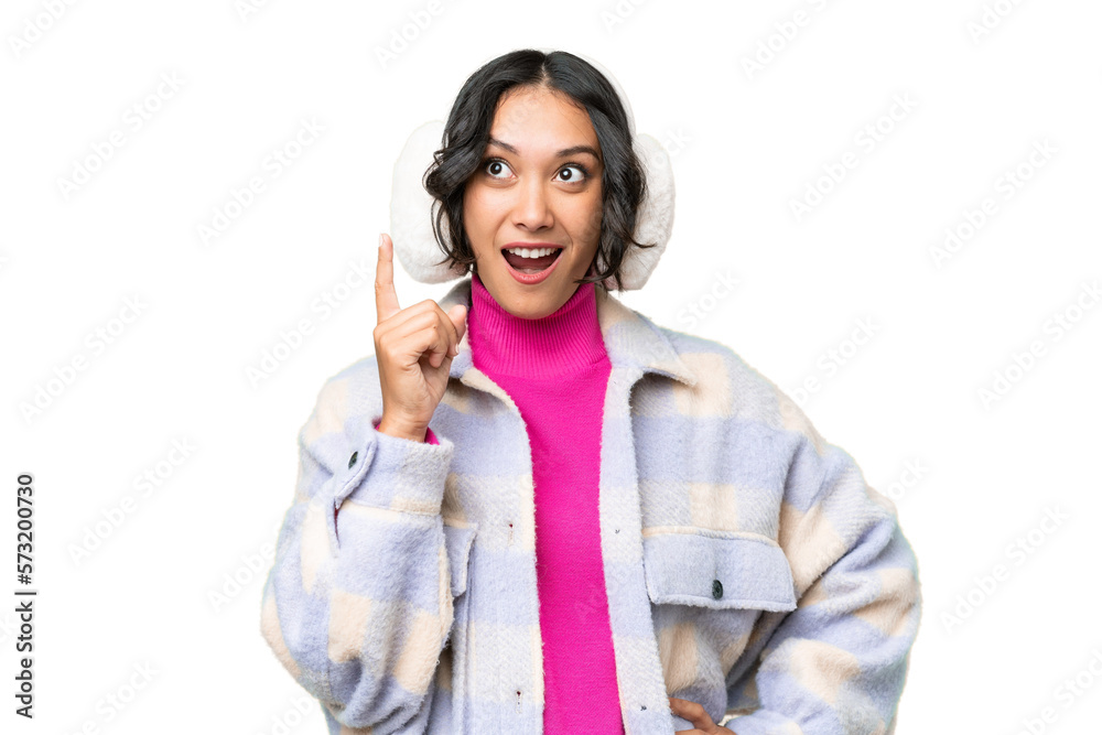 Young Argentinian woman wearing winter muffs over isolated background thinking an idea pointing the finger up Young Argentinian woman wearing winter muffs over isolated background thinking an idea pointing the finger up