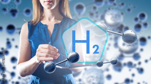 H2 logo near woman. Molecul...