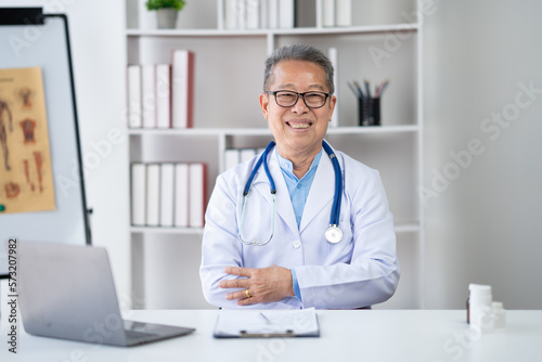 Portrait of expert mature doctor smiling in his office room with confidence.
