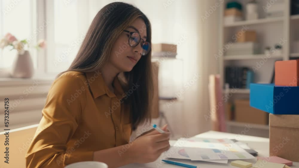 Young Korean woman drawing clothing sketches, apparel designer, creative job Young Korean woman drawing clothing sketches, apparel designer, creative job