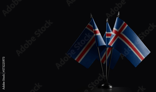 Small national flags of the Iceland on a black background