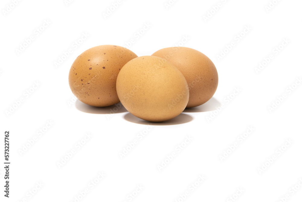 Three brown chicken eggs. Isolated on a white background. Vegetarian food concept. Three brown chicken eggs. Isolated on a white background. Vegetarian food concept.