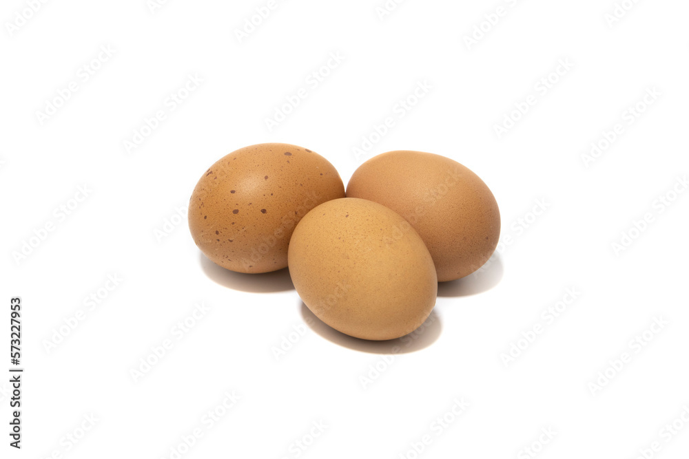 Three brown chicken eggs. Isolated on a white background. Vegetarian food concept. Three brown chicken eggs. Isolated on a white background. Vegetarian food concept.