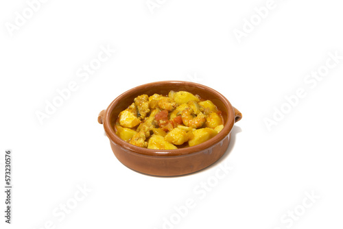 Potato stew with cod, served in a clay bowl. Isolated on white background. Spanish food concept.