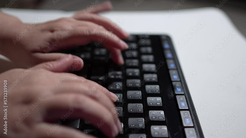 Close up select focus of woman hands speed typing on a black computer keyboard, Woman working with thai language keyboard at night in Thailand. Close up select focus of woman hands speed typing on a black computer keyboard, Woman working with thai language keyboard at night in Thailand.