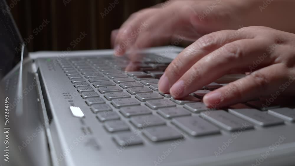 Close up select focus of woman hands typing on a laptop computer keyboard, Woman speed working with thai language keyboard at night in Thailand. Close up select focus of woman hands typing on a laptop computer keyboard, Woman speed working with thai language keyboard at night in Thailand.