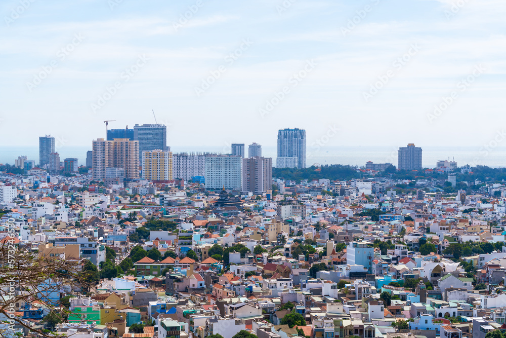 Morning in Vung Tau seen from above, with the most beautiful sea waves, coastline, streets, buidling, coconut trees and Tao Phung mountain in Vietnam. Travel concept.