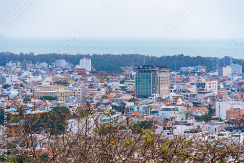 Morning in Vung Tau seen from above, with the most beautiful sea waves, coastline, streets, buidling, coconut trees and Tao Phung mountain in Vietnam. Travel concept.