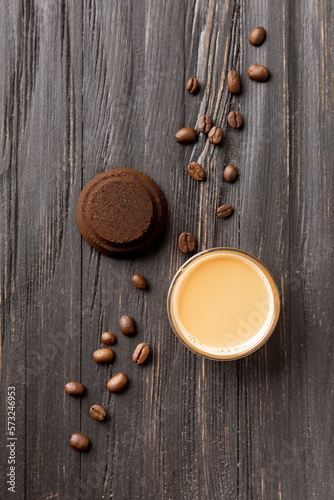 Waste coffee, cup of espresso on a black wooden background top view.