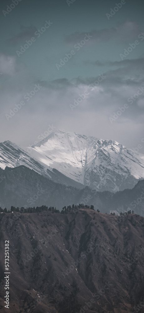 View of snowcapped mountains against cloudy sky