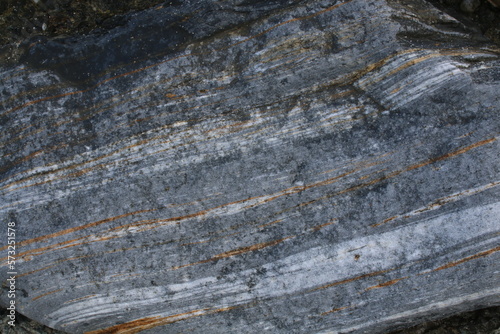 Background picture. Stone texture. Cut stone. Geological layers in the rock.