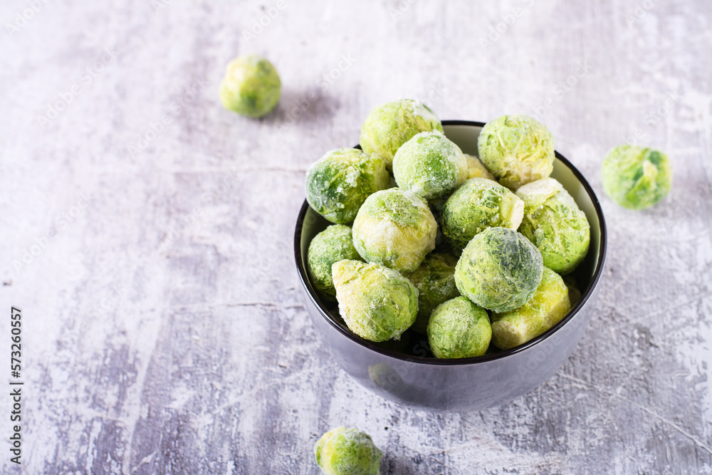 A bowl of frozen brussels sprouts on the table. Vegetable diet. A bowl of frozen brussels sprouts on the table. Vegetable diet.