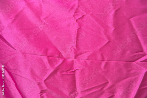 crumpled silk fabric pink color magenta. background.