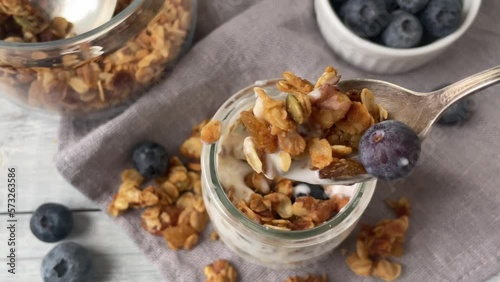 Yogurt with muesly and blueberries. Breakfast. Top view.