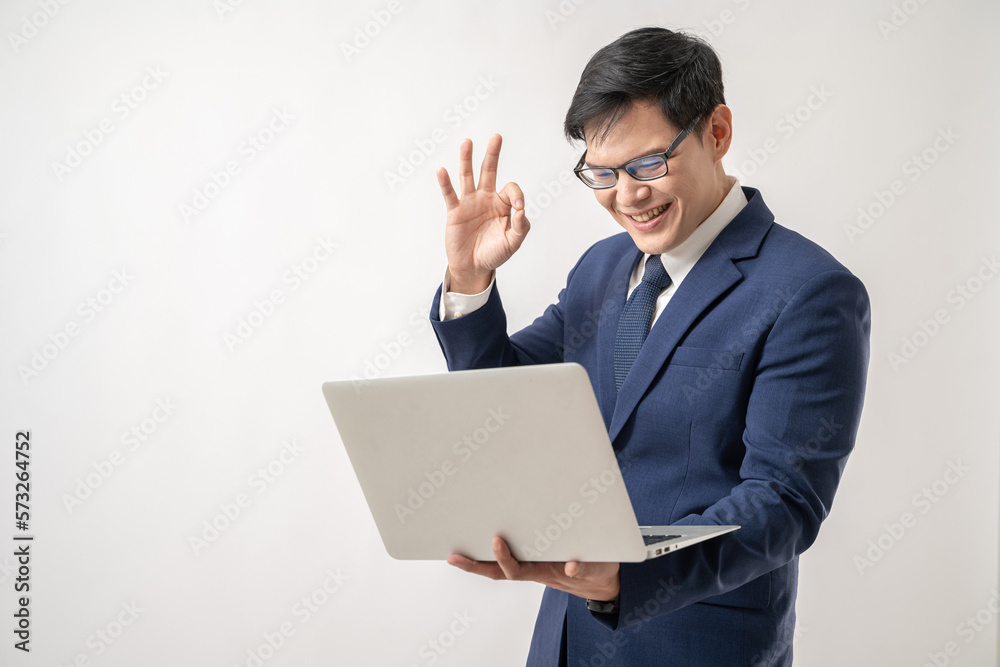 Portrait of confident Asian businessman in glasses holding laptop in hand isolated on white background Portrait of confident Asian businessman in glasses holding laptop in hand isolated on white background