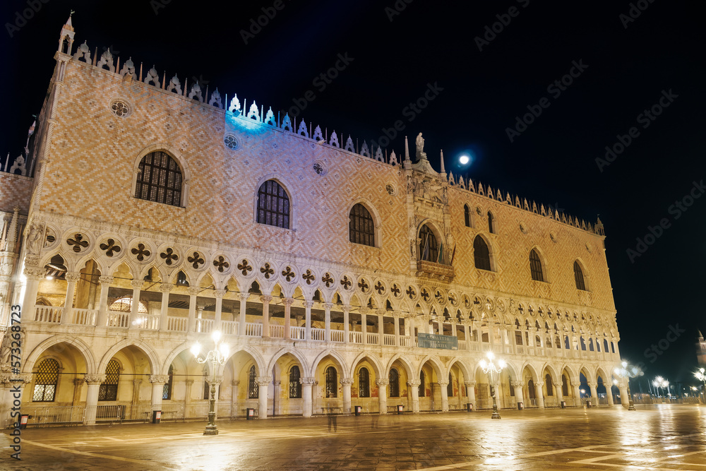 Venice Italy night view of illuminated Palazzo Ducale landmark, 1340 Doges Palace built in Venetian Gothic style at St. Marks square.