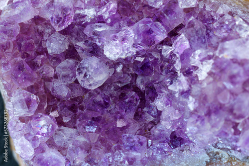 Crystal stone is a mineral. Purple rough amethyst quartz crystals, close up macro