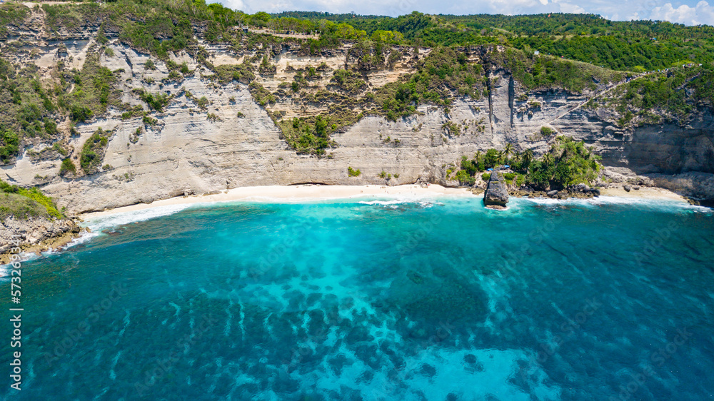Aerial drone view to beautiful sandy beach (Diamond beach) with rocky mountains and clear water in Nusa Penida, Bali, Indonesia