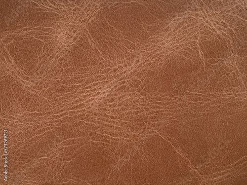 Red quality leather, natural material with design lines pattern or soft brown abstract background. Use as wallpaper or backdrop luxury event, design upholstered furniture, clothing. Genuine texture.