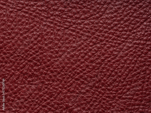 Red quality leather, natural material with design lines pattern or red abstract background. Can use wallpaper or backdrop luxury event, design upholstered furniture, clothing. Genuine leather texture.