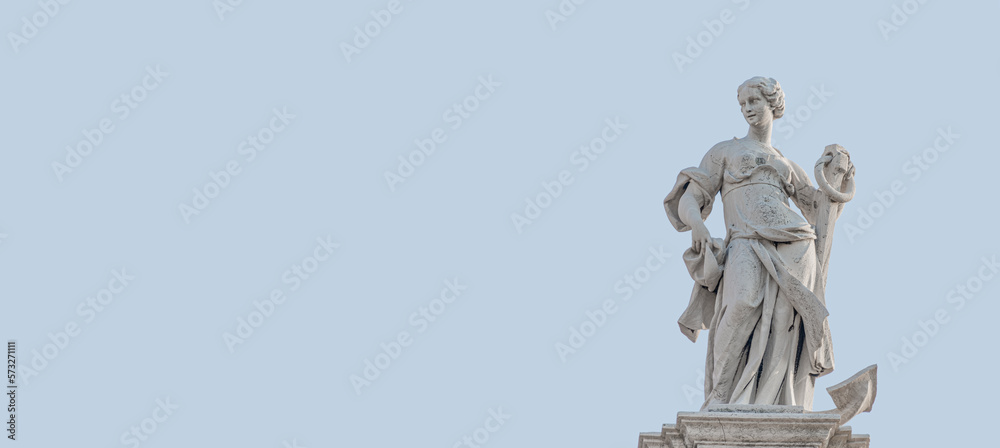 Banner with a ancient statue of a beautiful woman holding a big marine anchor at the top roof of the church of San Stae in Venice, Italy, at blue sky solid background and copy space.