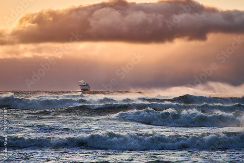 A ship during a storm at sea. A large ferry moves across the sea during a hurricane