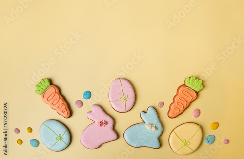 easter concept. sweets in the form of Easter eggs. easter theme on yellow background